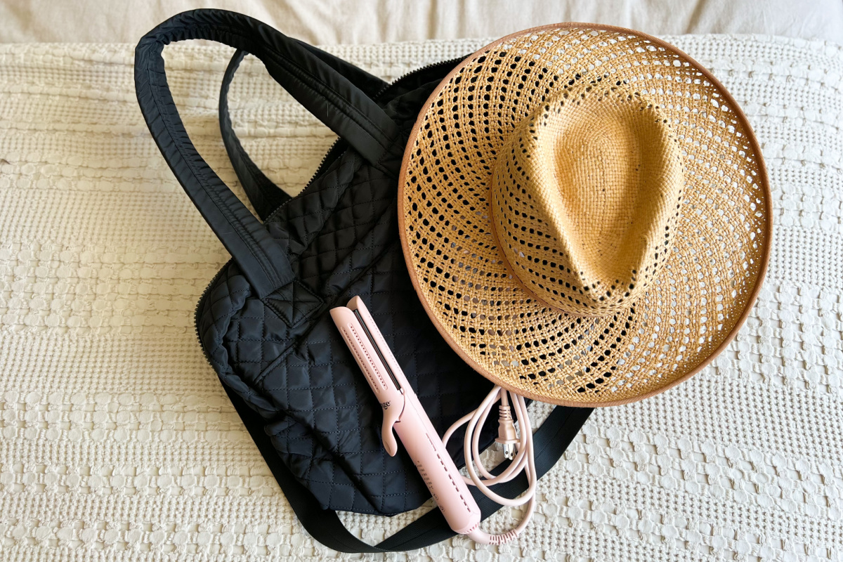 pink styling iron on weekender bag with hat