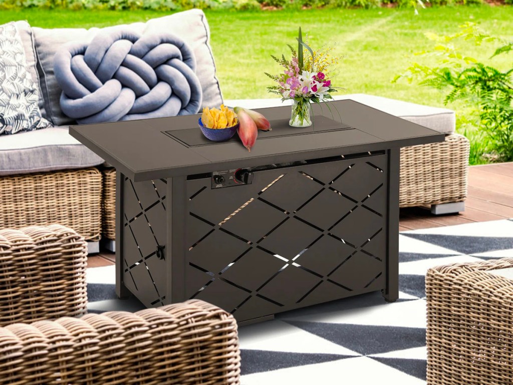 brown table firepit next to patio furniture