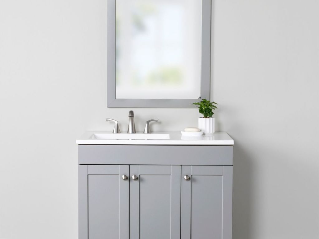 gray vanity with white top and matching mirror