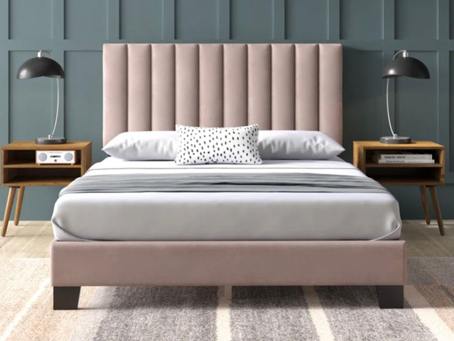 pink platform bed with white bedding