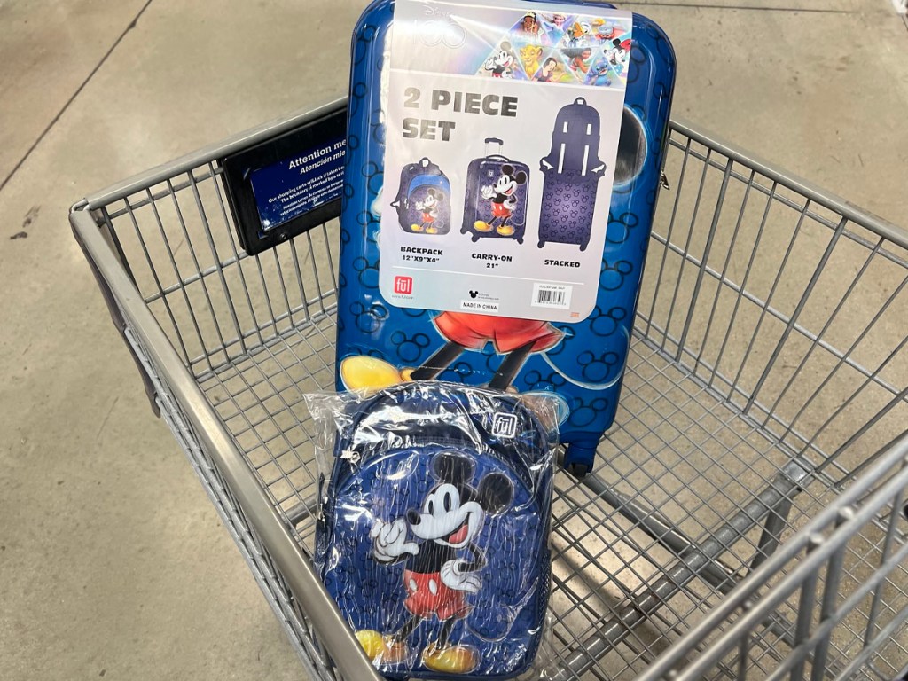 mickey mouse luggage and backpack in shopping cart