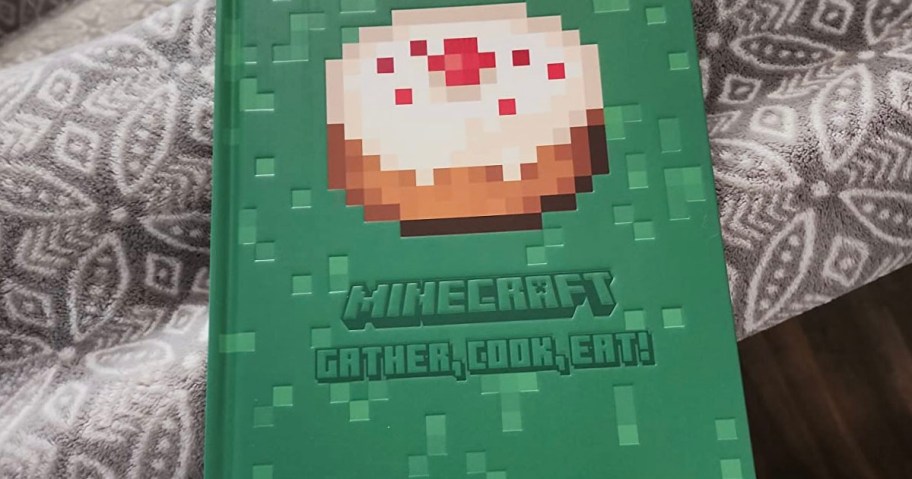 green minecraft recipe book laying on blanket