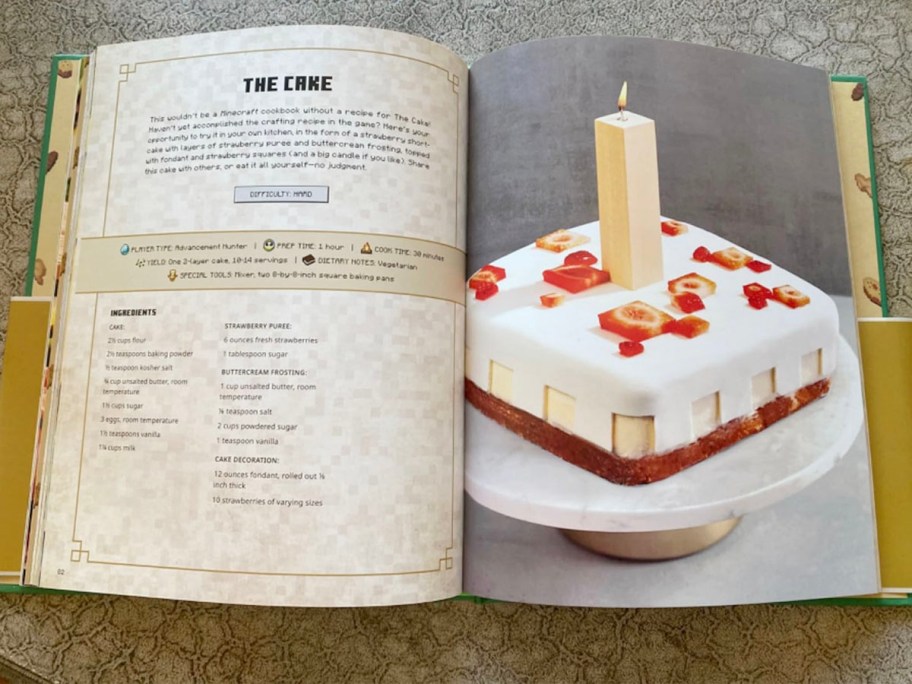 minecraft recipe book laying open with cake recipe on page