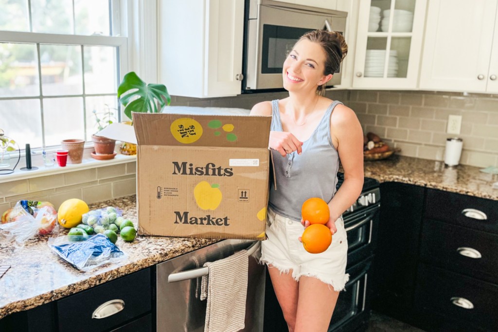 woman unpacking misfits market box