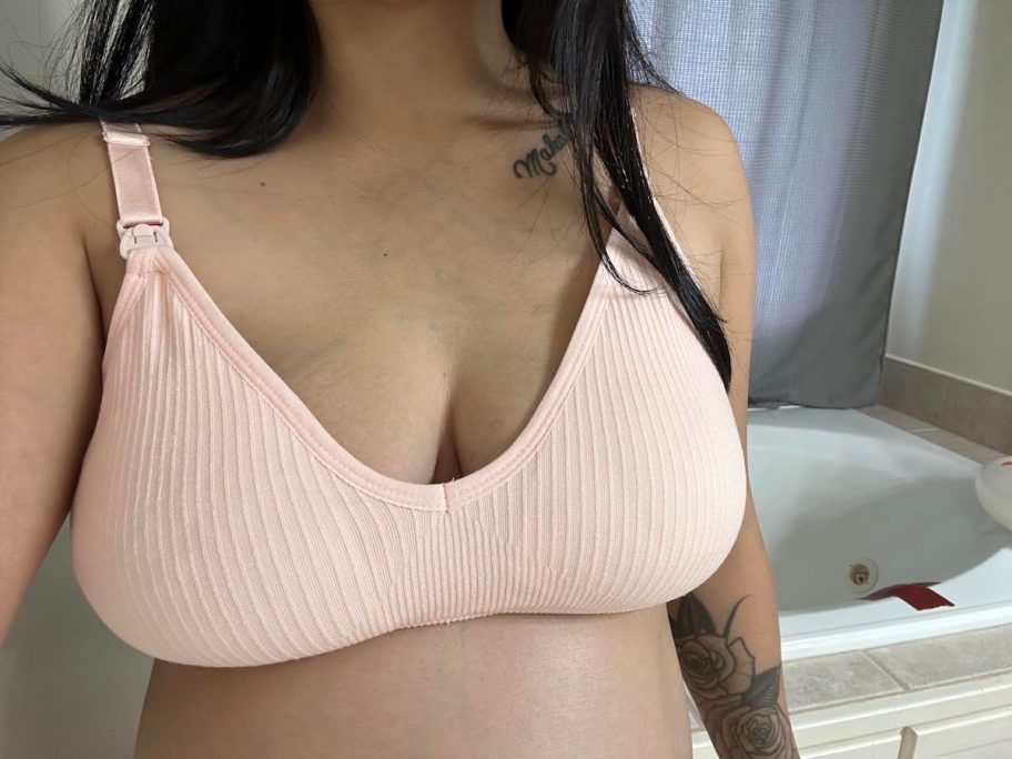 close up of woman wearing pink nursing bra