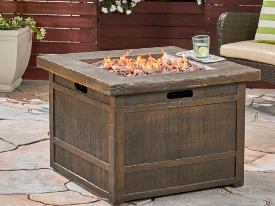 outdoor fire pit with drink on the side displayed outdoors