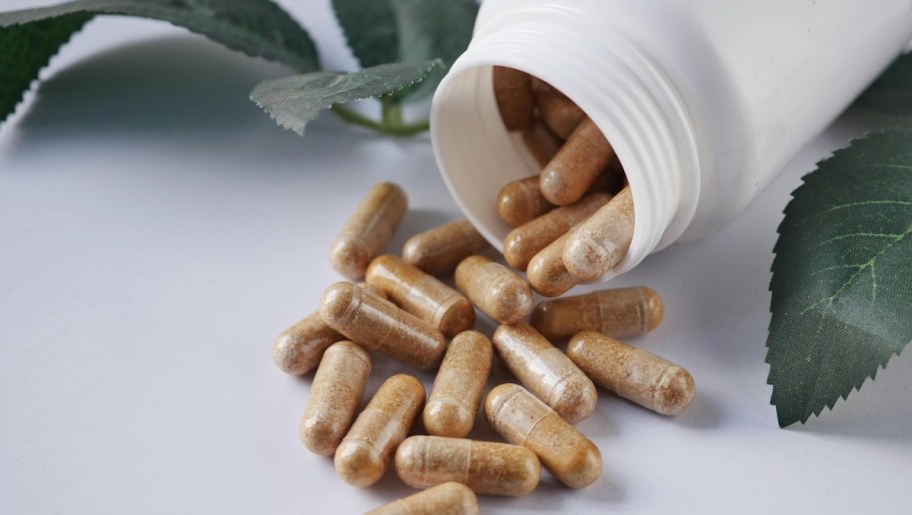 pills spilling out of white bottle