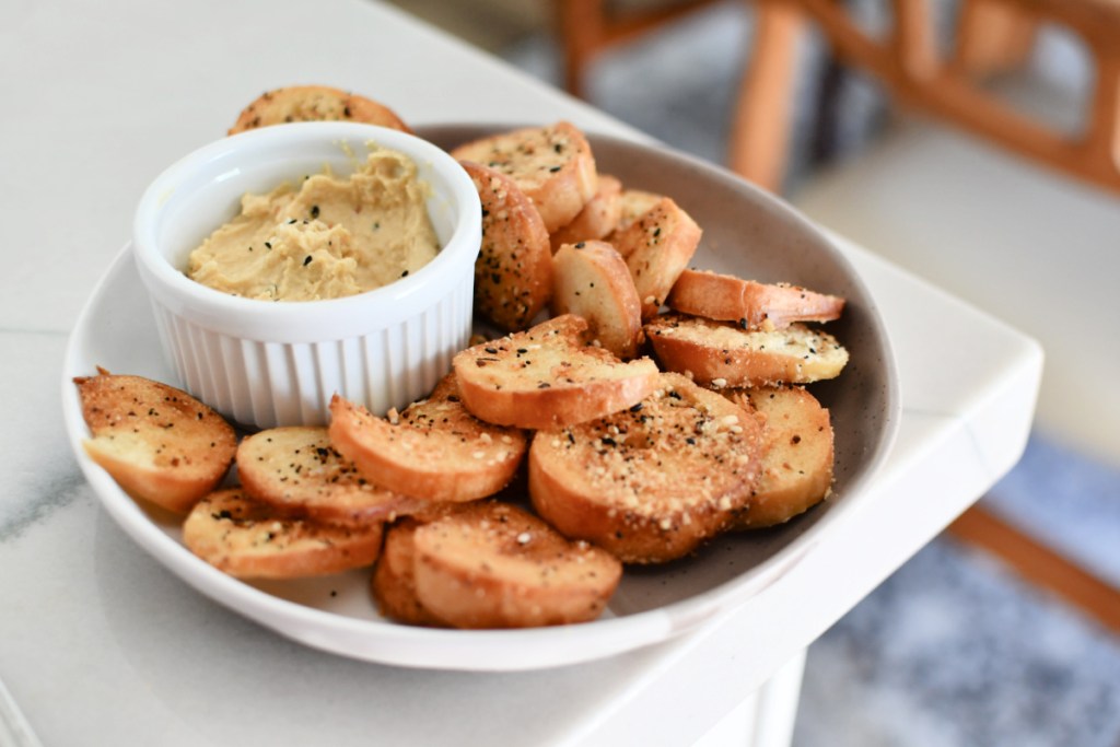 plate of bagel chips with hummus dip