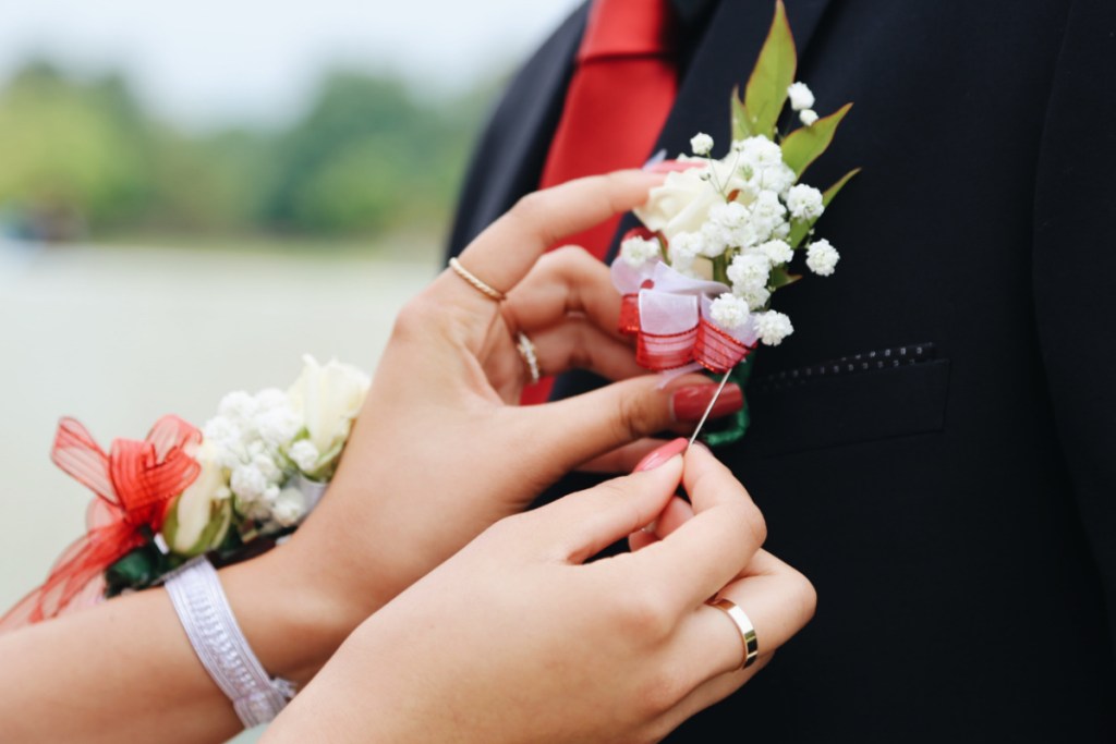 teen putting on prom boutonniere