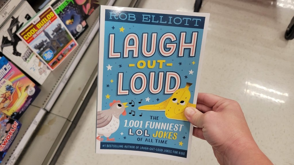 holding a joke book for teens