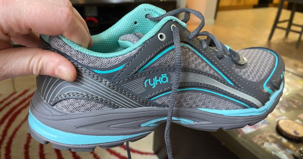 hand holding teal and gray ryka shoe