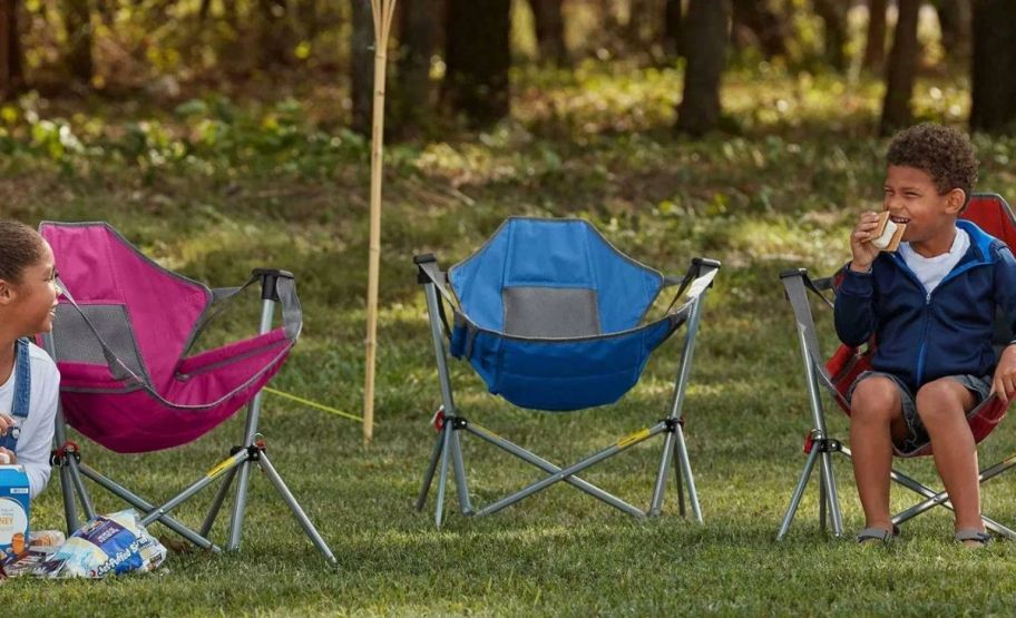 3 Sam's club swing lounger chair for kids on ground with two kids siting in them