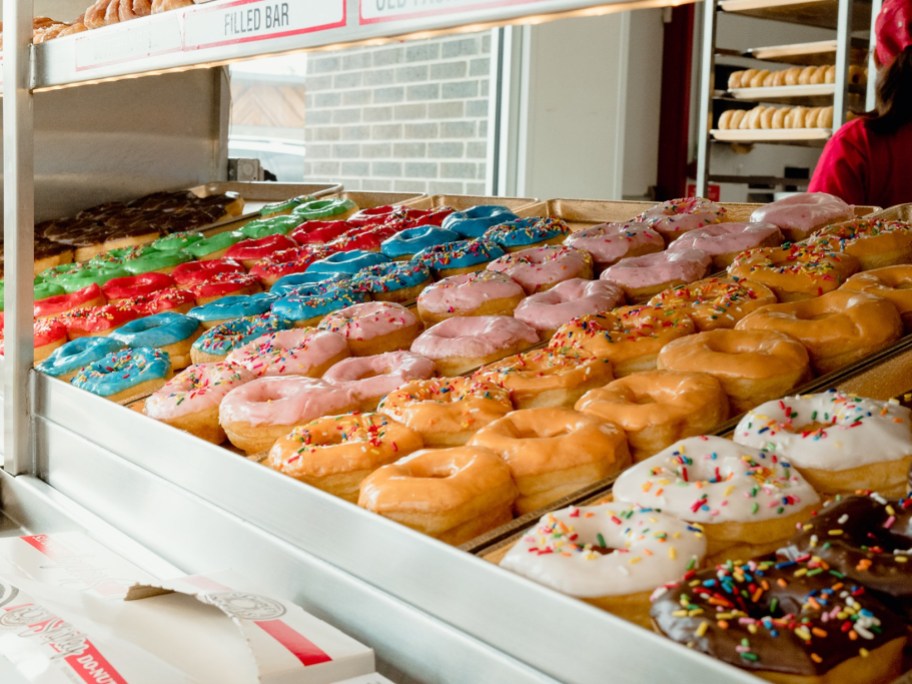 a variety of doughnuts displayed in a case
