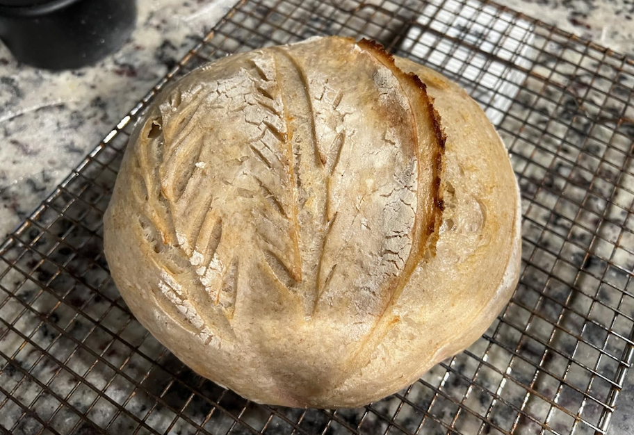 sourdough bread loaf on cooling rack