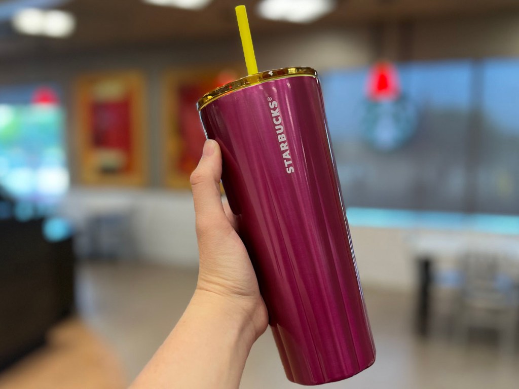 hand holding pink stainless steel tumbler