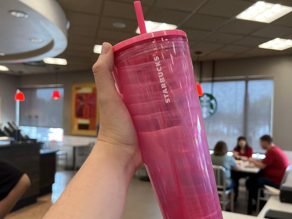 hand holding pink starbucks tumbler