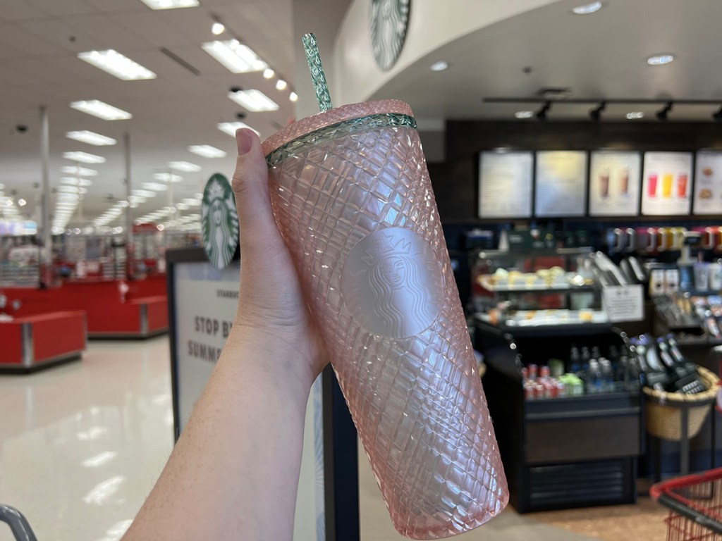 hand with pink tumbler