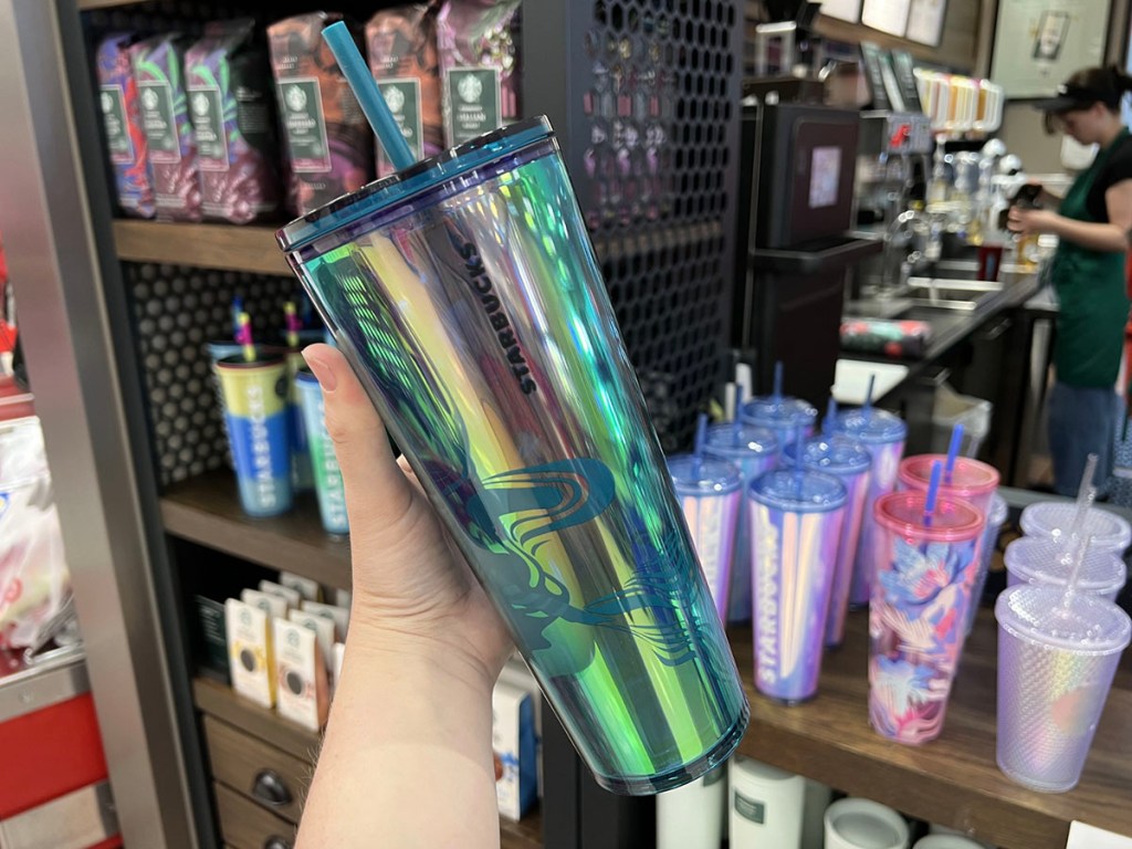 hand holding green starbucks tumbler