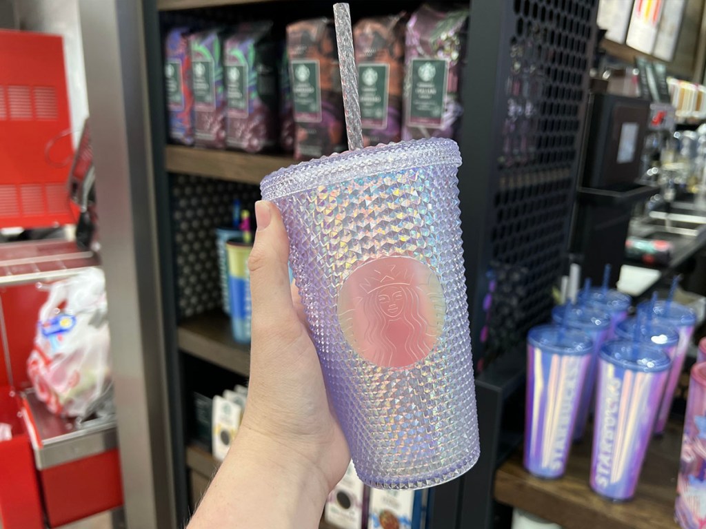 hand holding white studded starbucks tumbler 