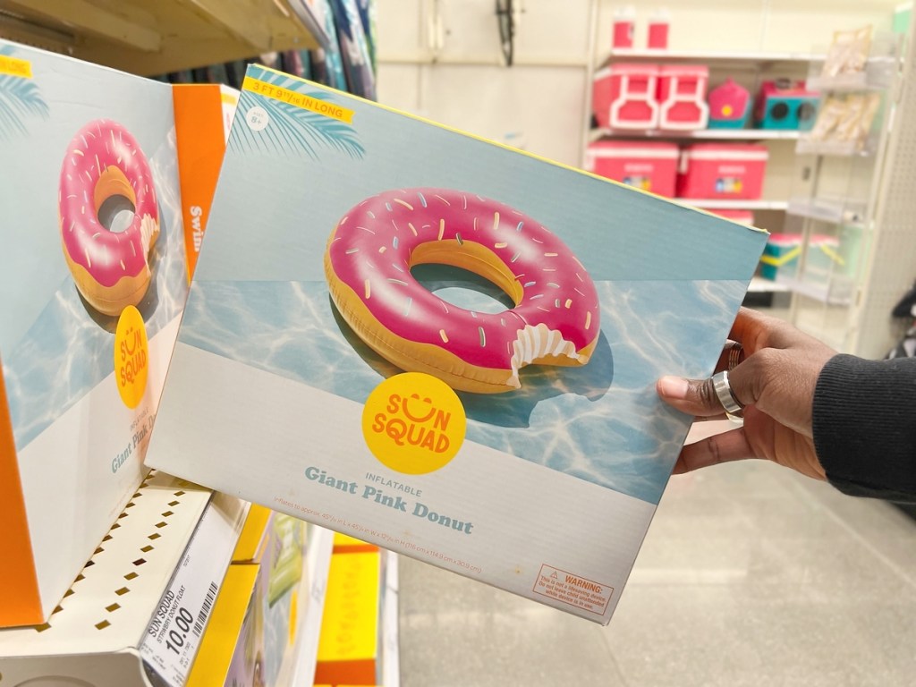 holding a boxed inflatable doughnut