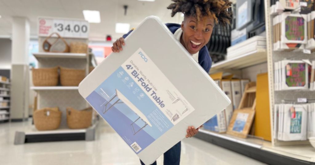 person carrying 4' folding table in Target