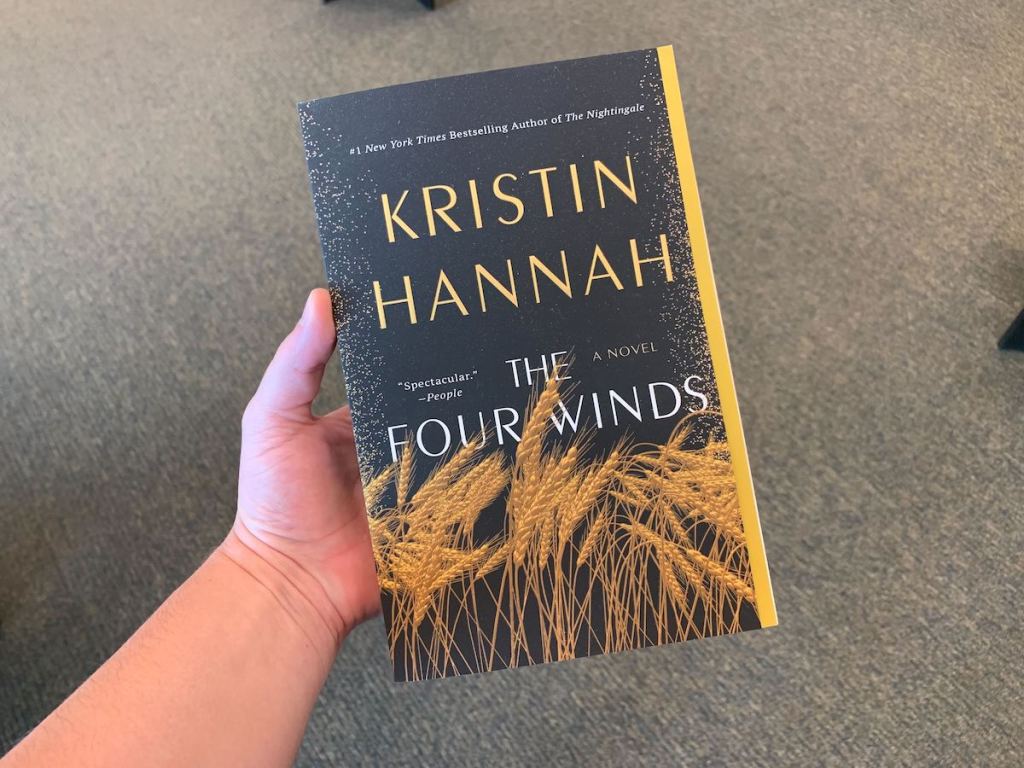hand holding the four winds book