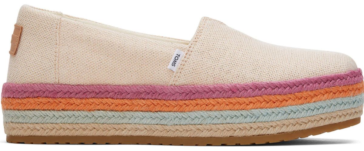 tan canvas Toms with purple, pink, blue and tan braided rope around bottom