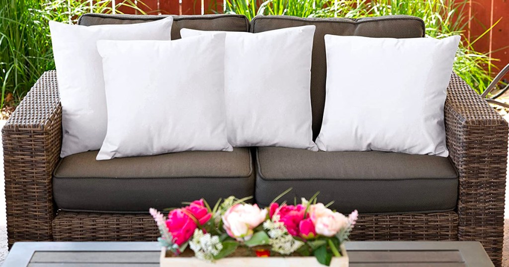 four white throw pillows on outdoor couch