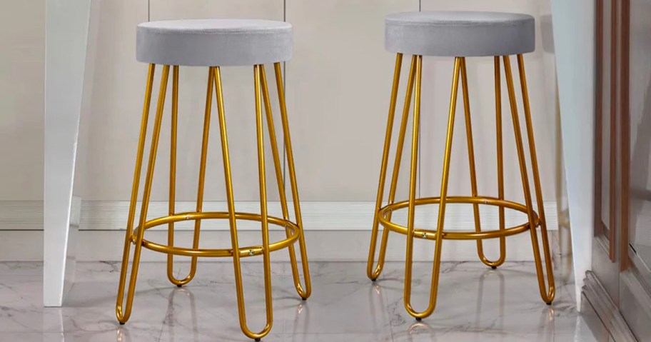 two gray and gold barstools