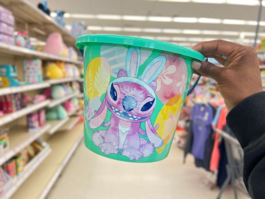 hand holding a green Disney Angel from Lilo & Stitch Plastic Easter Bucket 