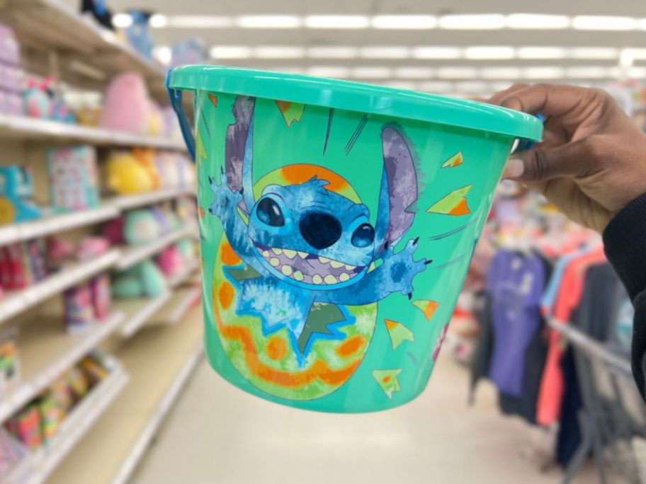 hand holding a green Disney Stitch Plastic Easter Bucket 