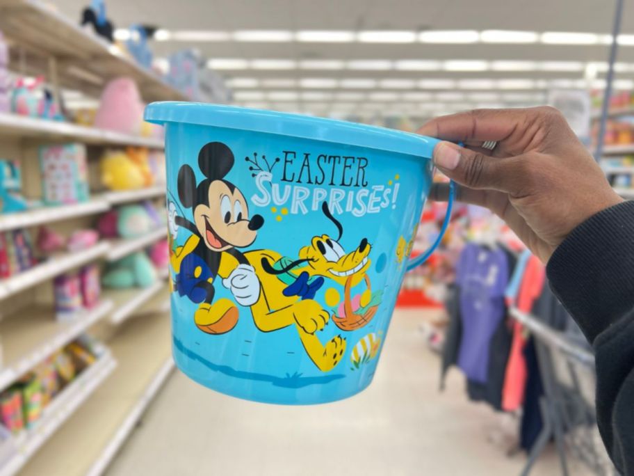 hand holding a blue Disney Mickey & Pluto Plastic Easter Bucket 