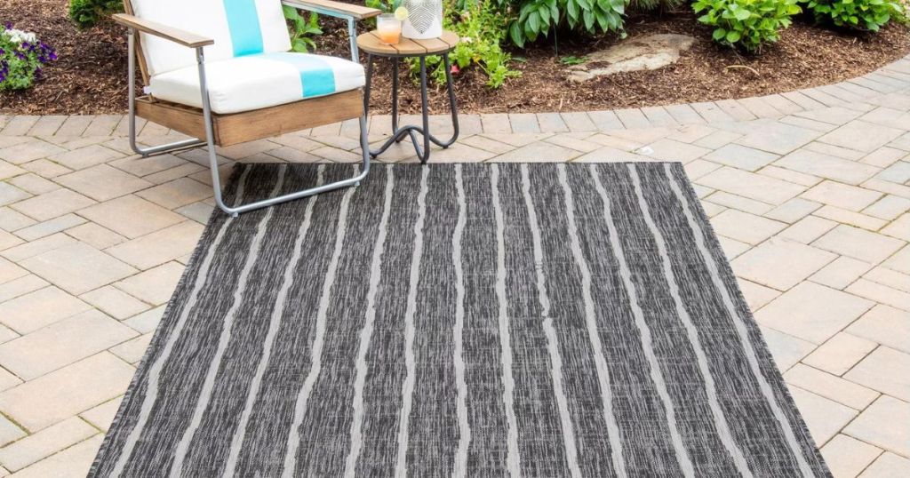 charcoal and white striped area rug on patio 