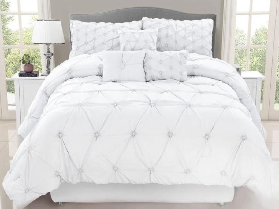white comforter set on bed in bedroom