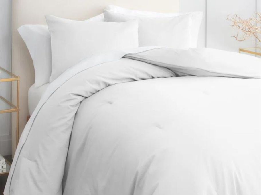 gray comforter set on bed in bedroom