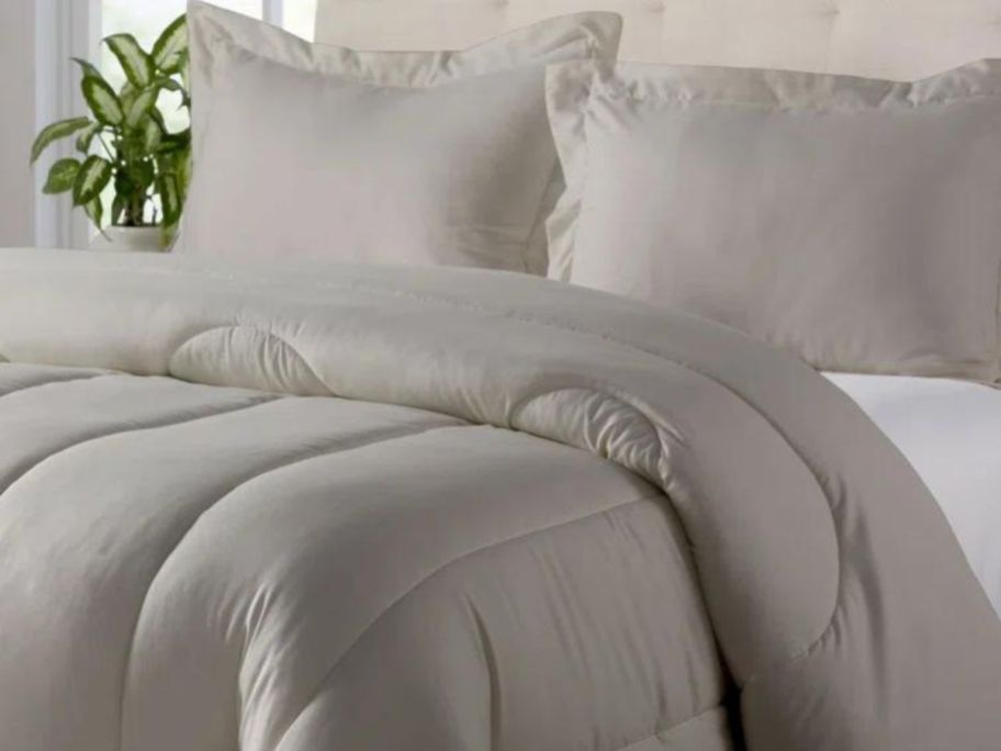 gray comforter set on bed in bedroom