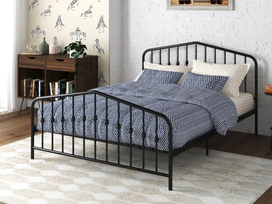 metal bed with blue comforter set on top