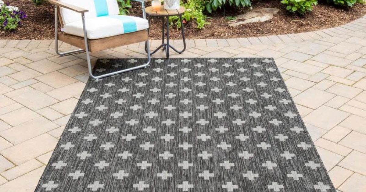 charcoal x patterned rug on patio with chair and table