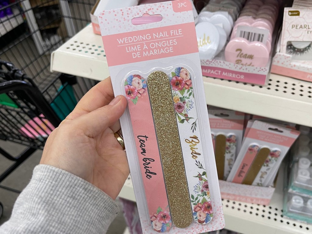 hand holding 3 pack nail file in pink, gold and floral