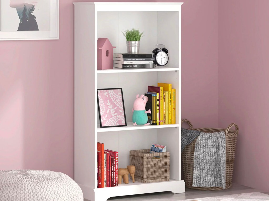 white 3 shelf bookcase with items on it
