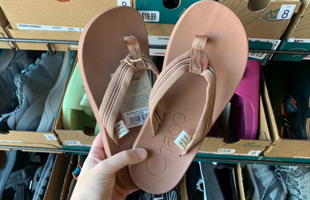 woman holding Chaco Women's Chillos Flip Flop at DSW store