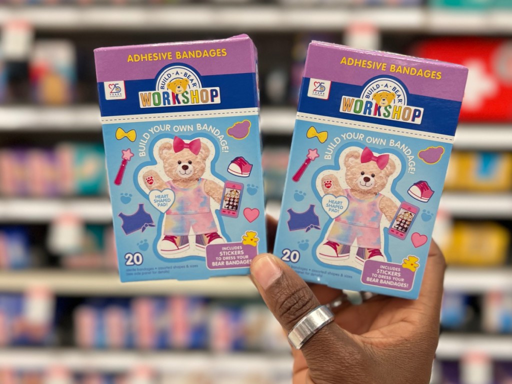 woman holding two build a bear bandages boxes