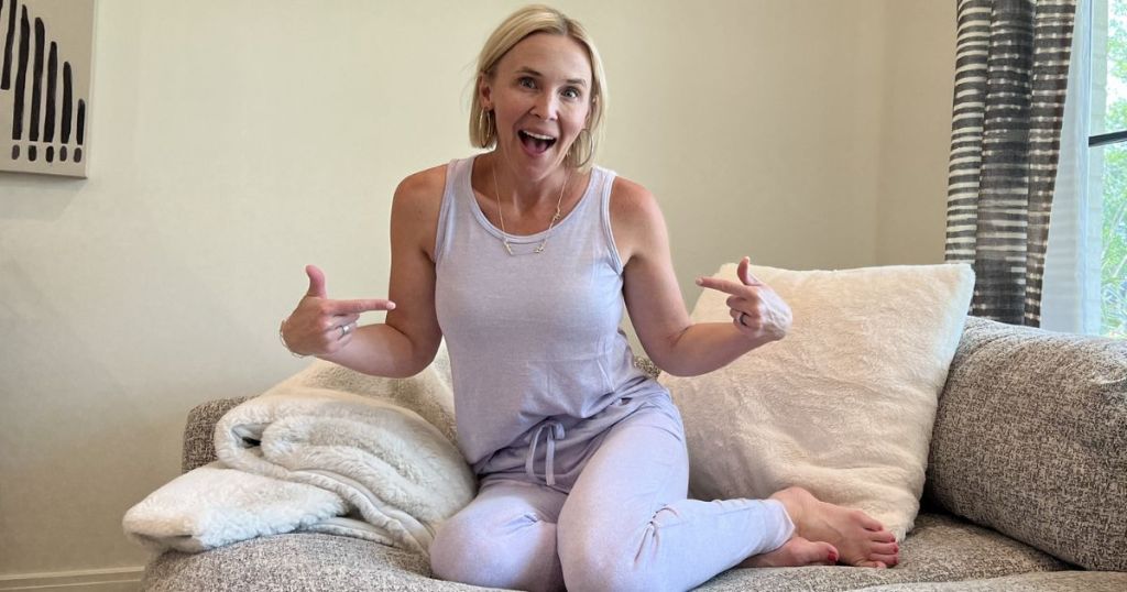 Woman wearing 32 degrees pajamas while sitting on a couch