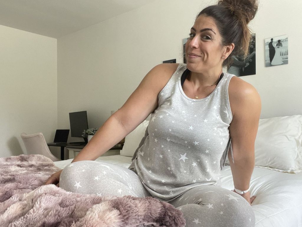 woman wearing 32 degrees pajamas while sitting on a bed