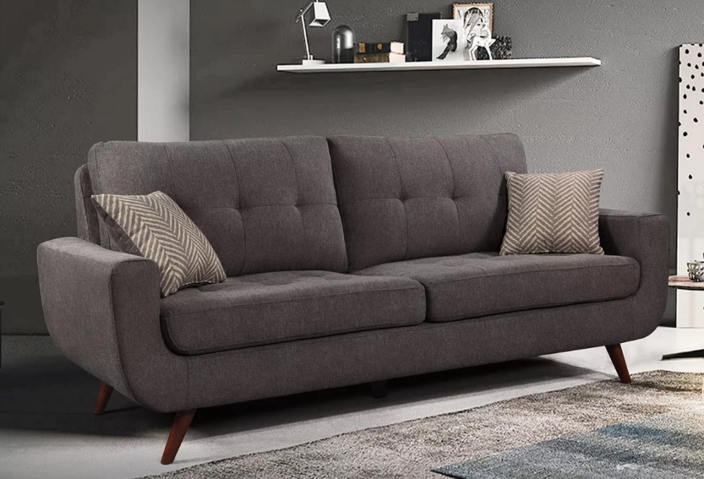 Grey couch with pillows on it