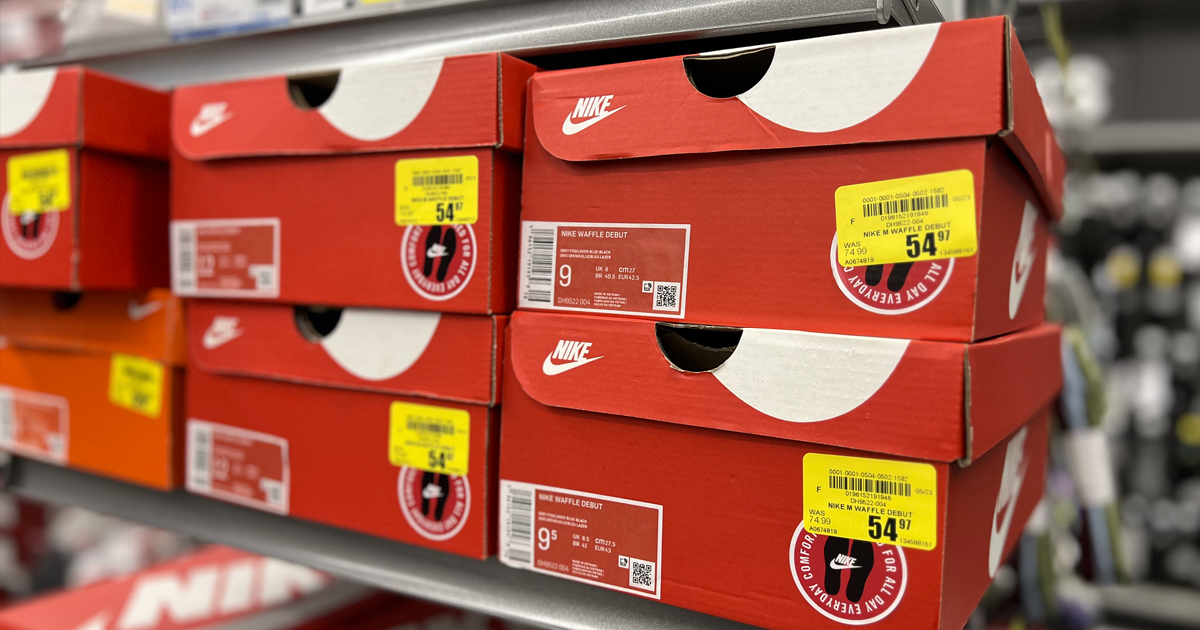 red nike shoe boxes with yellow clearance tags on store shelf