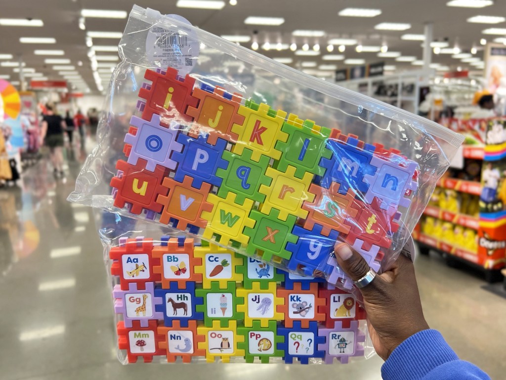 hand holding up two bags of Alphabet Puzzle Connectors