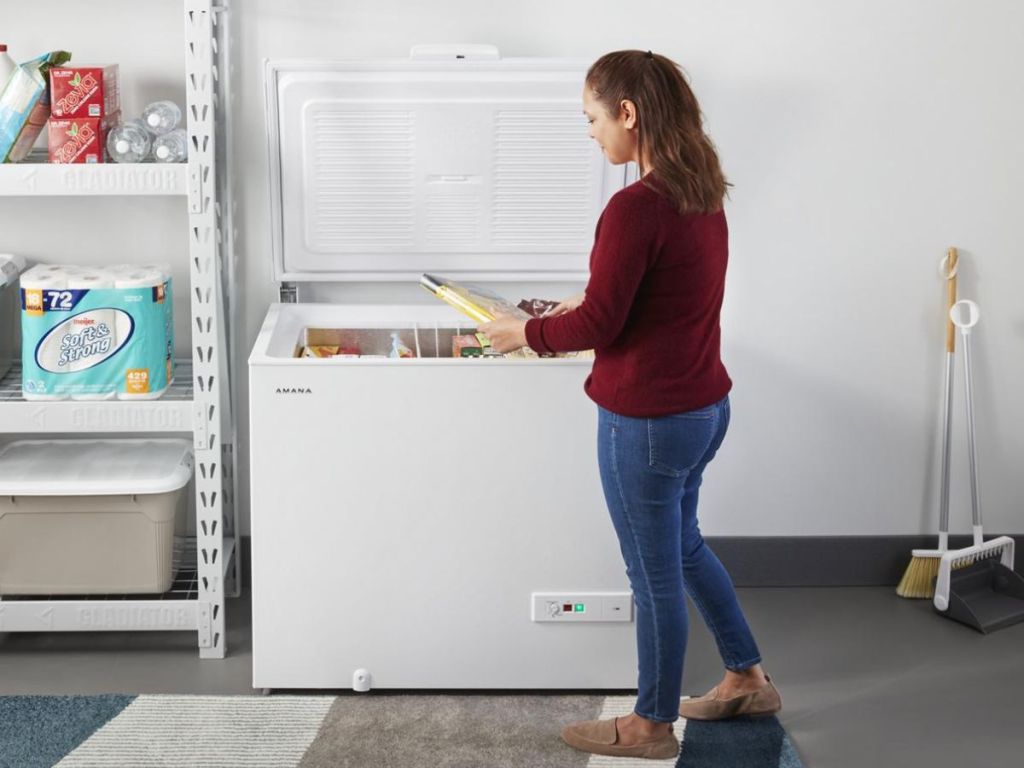 Woman standing by a chest freezer