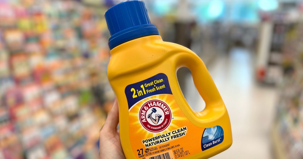 Arm & Hammer Laundry Bottle being held by a woman in the aisle at Walgreens