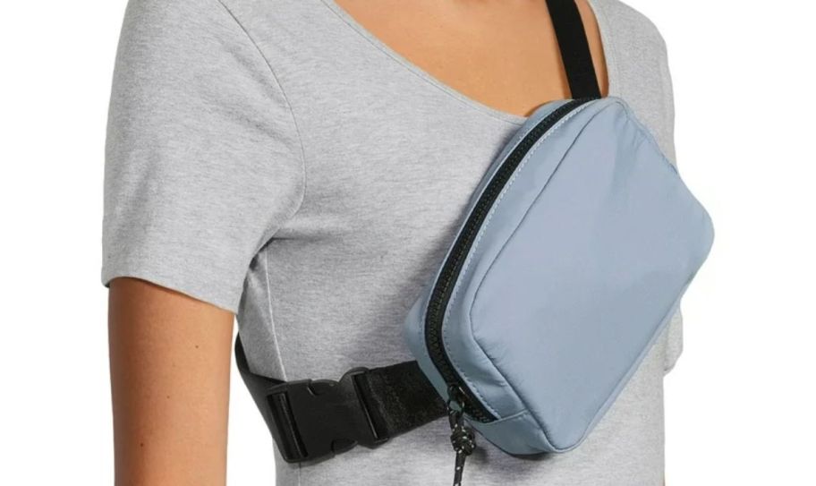 a model wearing a light blue belt bag crossbody